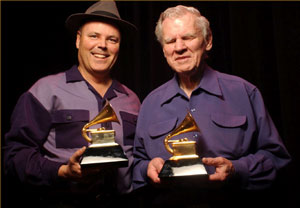 Photo of David Holt and Doc Watson receiving their Grammy award for  Best Traditional Folk Music Recording of 2002.