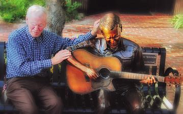 Photo of Doc Watson sitting on the bench and statue of him in Boone, NC.